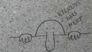 Cartoon figure of a face looking over a wall